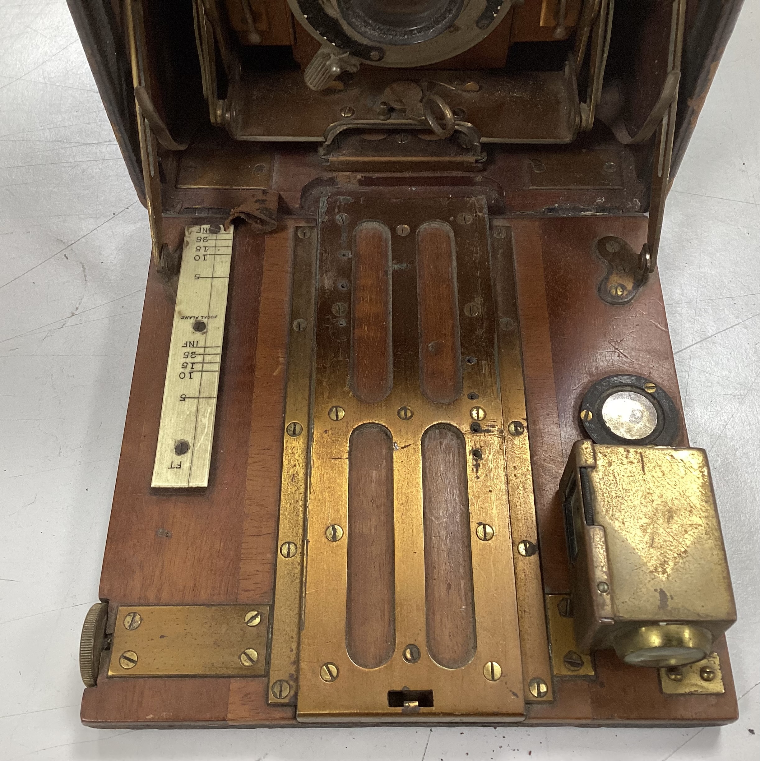 An Edwardian quarter plate camera, an early 20th century gilt decorated metal and Bakelite telephone, two Edwardian car lamps and a hand lamp etc.